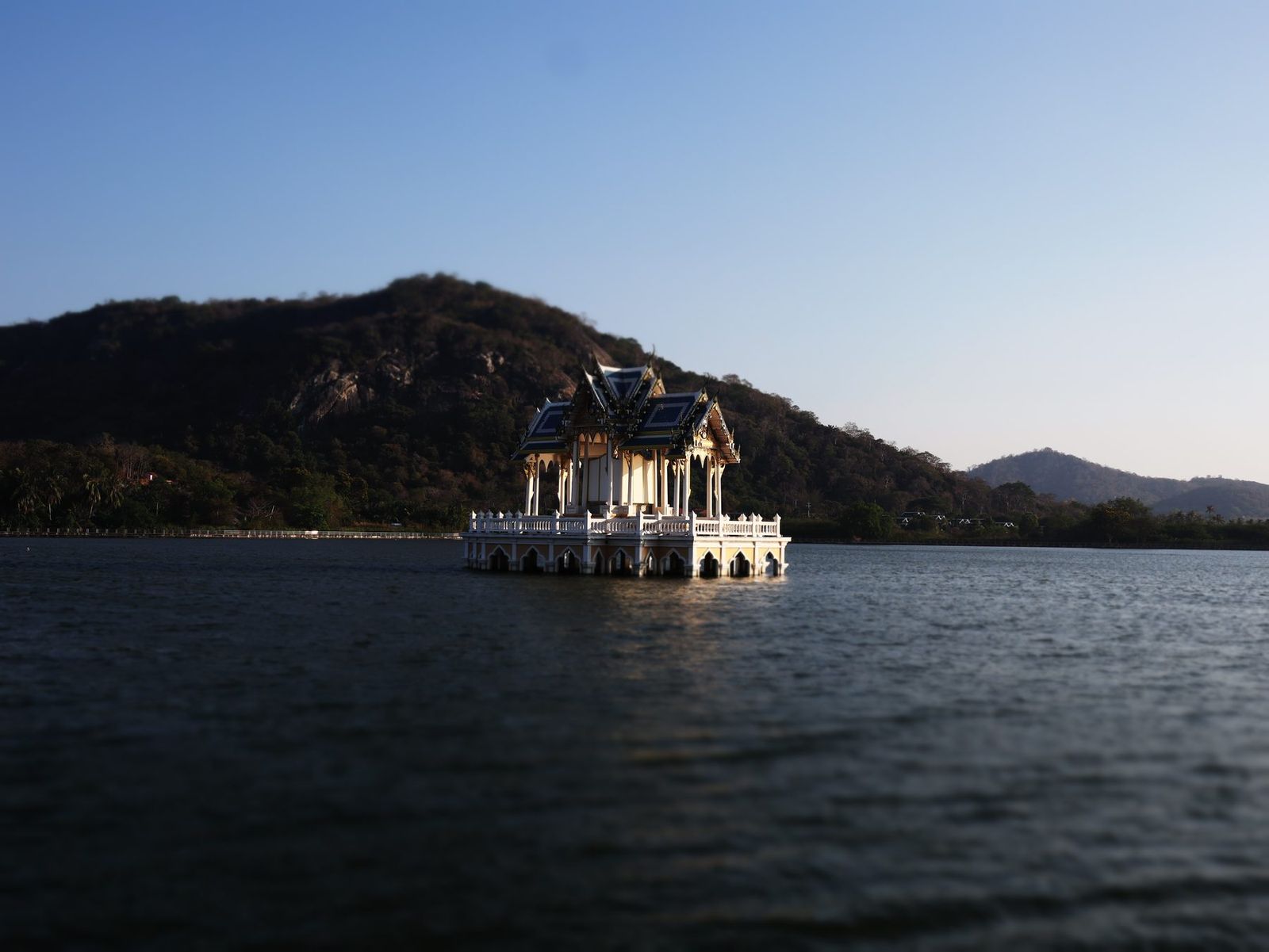 A Thai pavilion on a lake beneath the mountains near Hua Hin